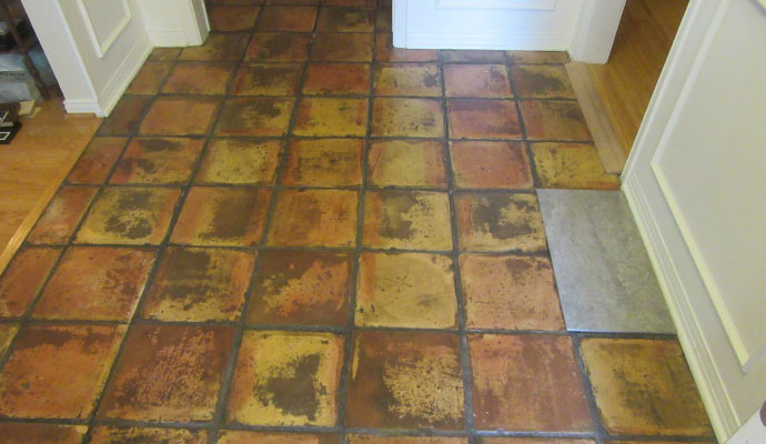 Worn, discolored old tiled floor