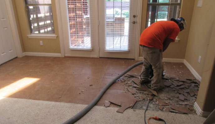 Professional worker removing tile